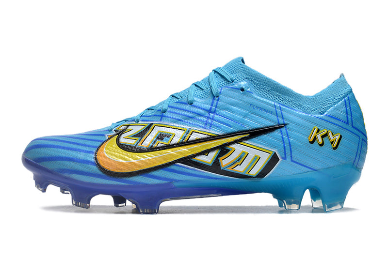 CHUTEIRA NIKE AIR ZOOM MERCURIAL VAPOR 15 ELITE CAMPO "MBAPPÉ COMIC" - AZUL E AMARELA