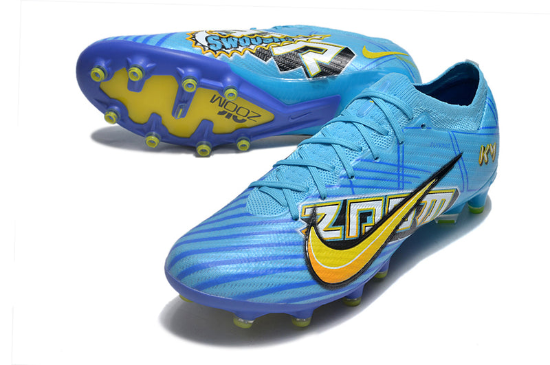 CHUTEIRA NIKE AIR ZOOM MERCURIAL VAPOR 15 ELITE CAMPO (AG) "MBAPPÉ COMIC" - AZUL E AMARELA