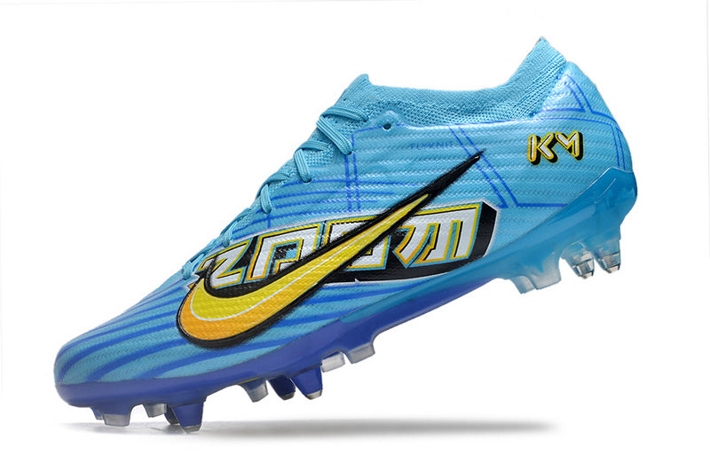 CHUTEIRA NIKE AIR ZOOM MERCURIAL VAPOR 15 ELITE TRAVA MISTA FIXA "MBAPPÉ COMIC" - AZUL E AMARELA