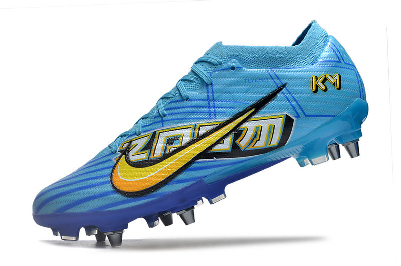 CHUTEIRA NIKE AIR ZOOM MERCURIAL VAPOR 15 ELITE TRAVA MISTA "MBAPPÉ COMIC" - AZUL E AMARELA