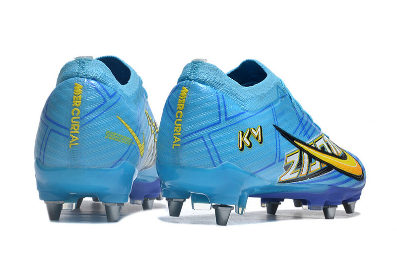 CHUTEIRA NIKE AIR ZOOM MERCURIAL VAPOR 15 ELITE TRAVA MISTA "MBAPPÉ COMIC" - AZUL E AMARELA