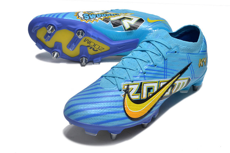 CHUTEIRA NIKE AIR ZOOM MERCURIAL VAPOR 15 ELITE TRAVA MISTA "MBAPPÉ COMIC" - AZUL E AMARELA